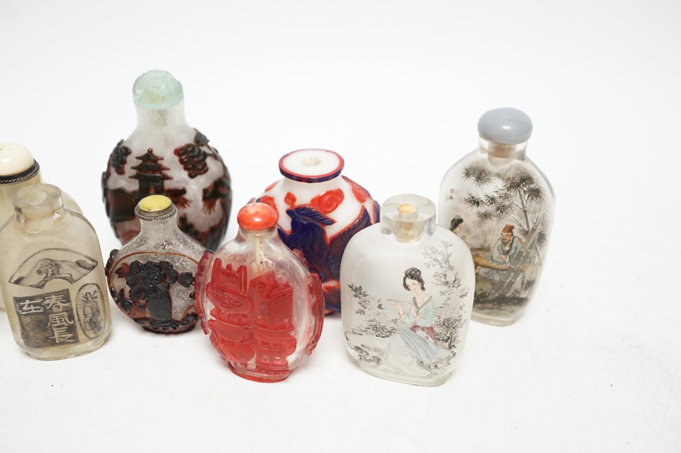 A group of Chinese cameo glass and inside painted glass and faux hardstone glass snuff bottles, largest 8.5cm high